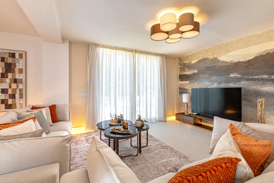 Interior design and architecture photograph of a bright living room with light sofas, circular coffee table in Cala de Mijas
