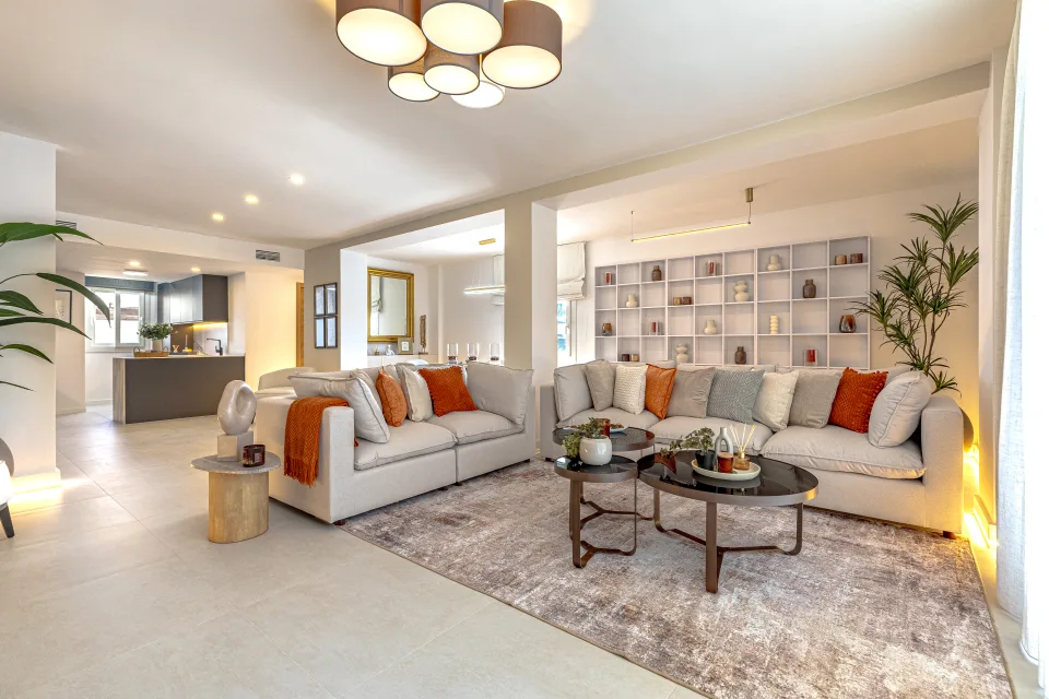 Interior design and architecture photograph of a bright living room with light sofas, terracotta accents in Cala de Mijas