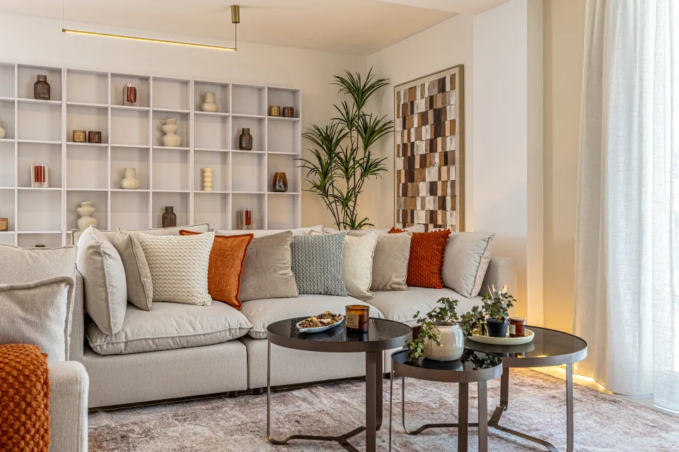 Interior design and architecture photograph of a bright living room with a light sofa, warm-toned cushions in Cala de Mijas