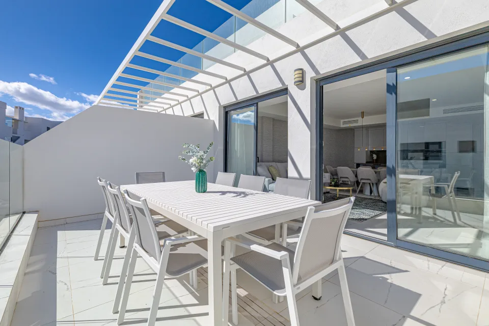 Vacation rental photograph of a spacious terrace with a white table and comfortable chairs, perfect for enjoying outdoor views in Casares Costa
