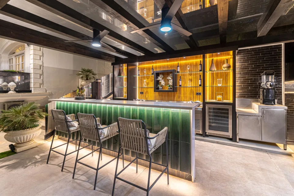 Fotografía de alquiler vacacional de un elegante bar con iluminación ambiental y taburetes de diseño en Marbella