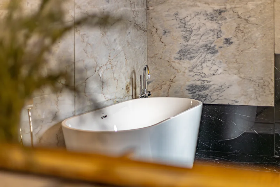 Fotografía de alquiler vacacional de una elegante bañera independiente de diseño moderno rodeada de mármol en Marbella