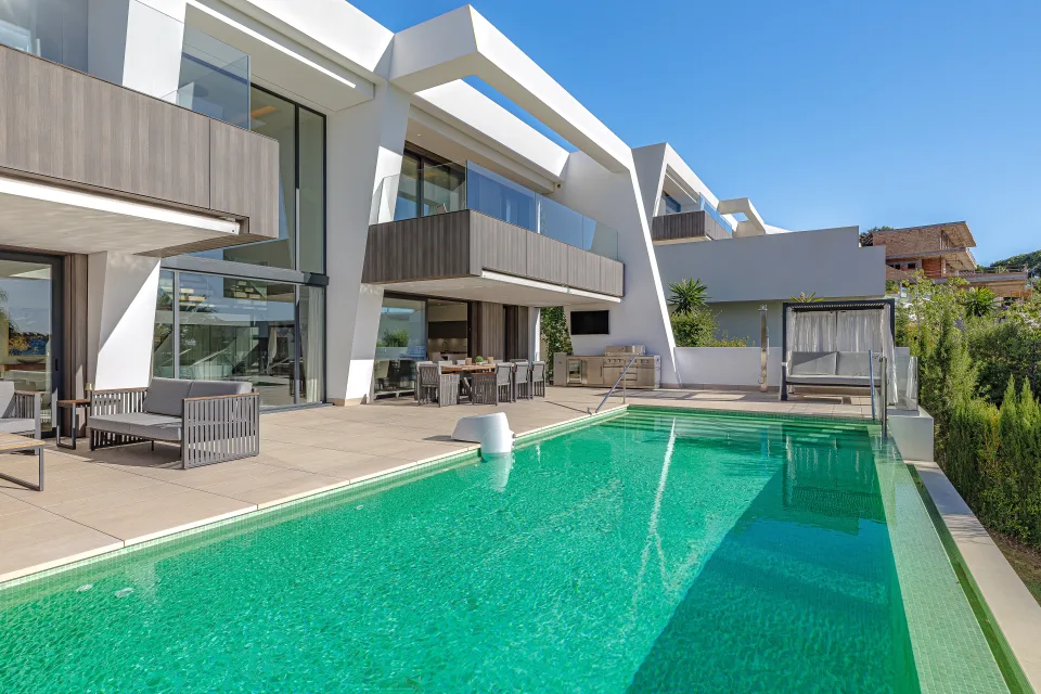 Interior design and architecture photograph of a modern villa with a swimming pool, spacious terraces and bright outdoor spaces in Estepona