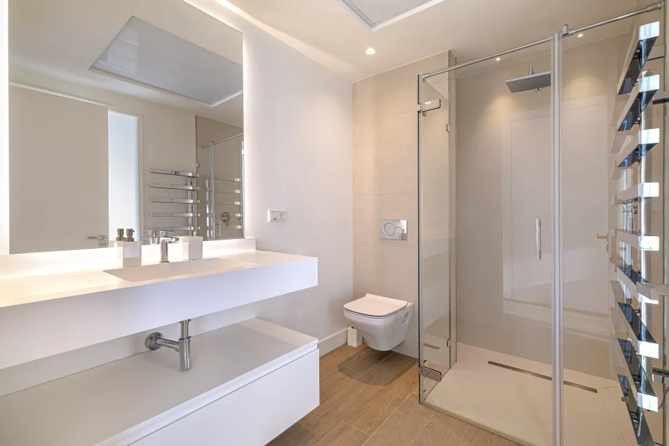 Interior design and architecture photograph of a modern bathroom with walk-in shower, illuminated double sink in Estepona