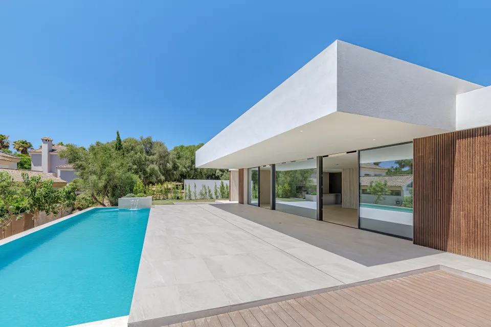 Architectural photograph of a modern villa with infinity pool, large windows in Sotogrande