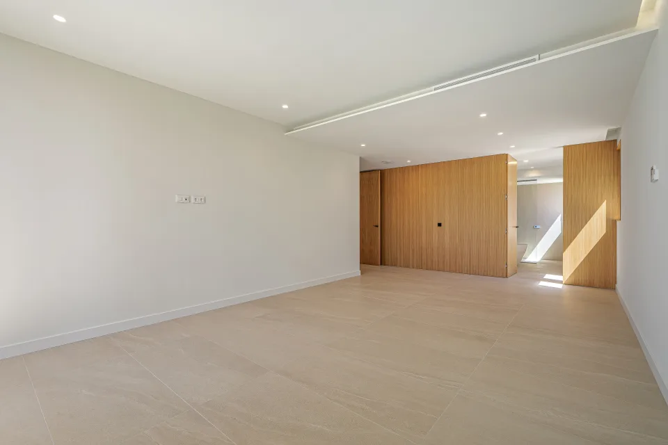 Architectural photograph of a spacious living room with stone flooring, neutral walls in Sotogrande