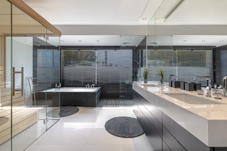 Interior design and architecture photograph of a contemporary bathroom featuring a jacuzzi shower, sauna, expansive mirrors in Guadalmina Baja