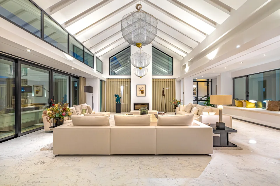 Interior design and architecture photograph of a spacious living room with high ceilings, large windows in Guadalmina Baja