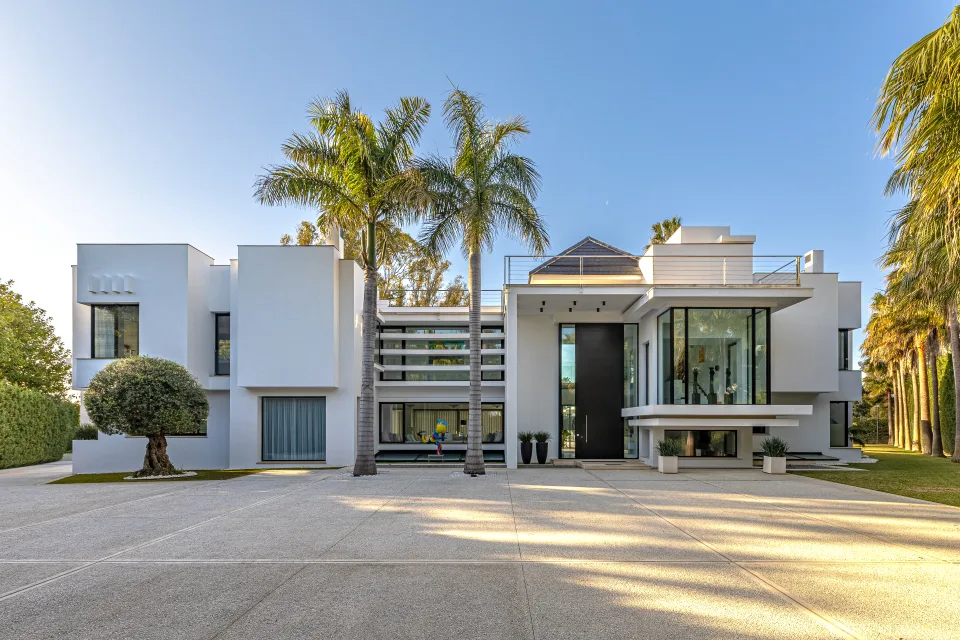 Fotografía de interiorismo y arquitectura de una villa moderna con grandes ventanales, iluminación natural en Guadalmina Baja