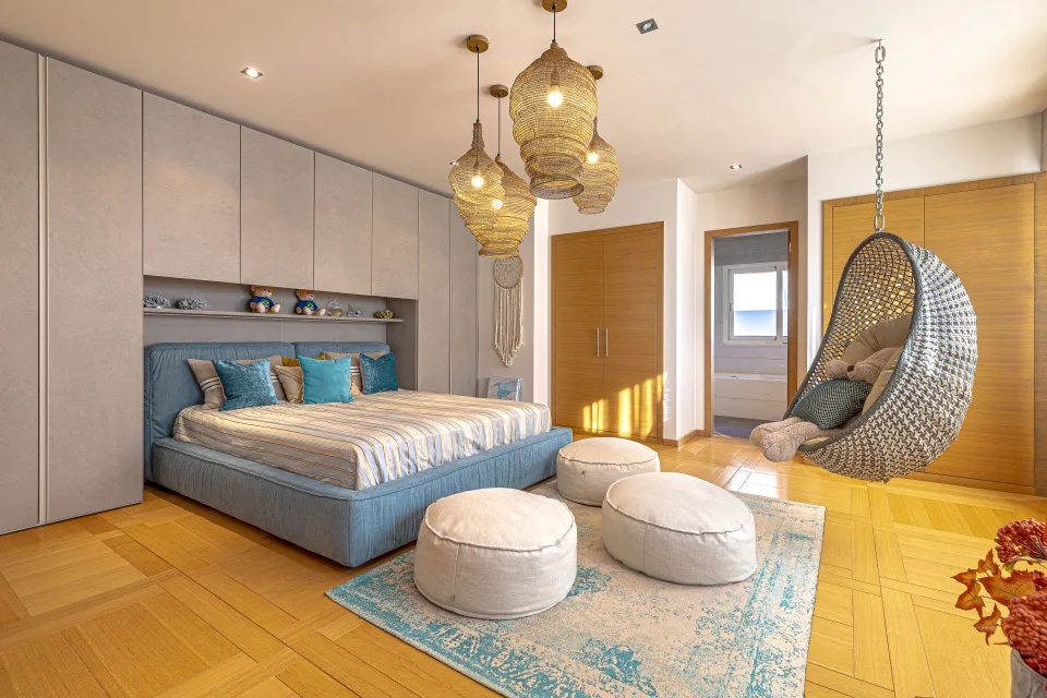 Fotografía inmobiliaria de un acogedor dormitorio con cama grande, luces colgantes y un columpio de mimbre en Marbella
