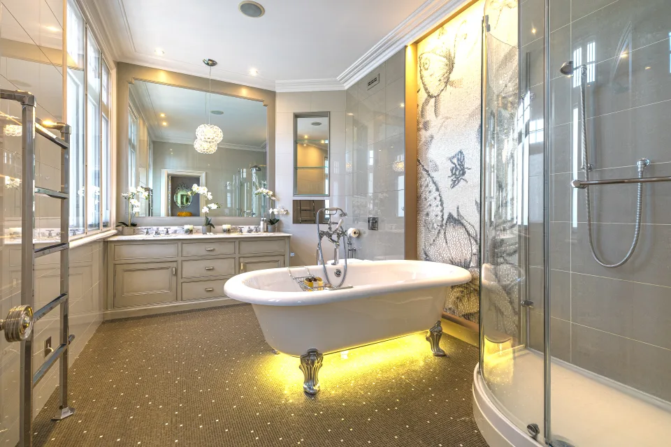 Real estate photograph of a contemporary bathroom featuring a freestanding bathtub, glass shower and elegant lighting in London