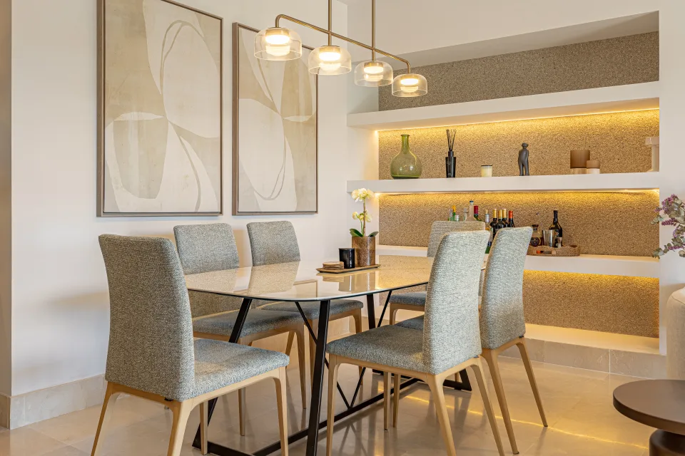 Interior design and architecture photograph of a stylish dining room with a glass table and upholstered chairs in Sotogrande