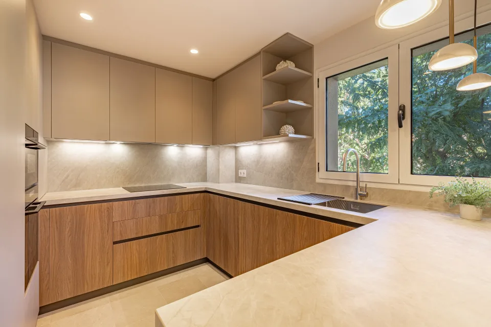 Interior design and architecture photograph of a modern kitchen with wooden cabinetry, stone countertops in Sotogrande